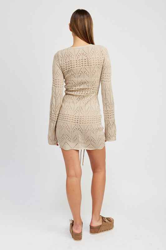Back view of Emory Park ruched crochet mini dress with long sleeves and adjustable waist for a stylish look