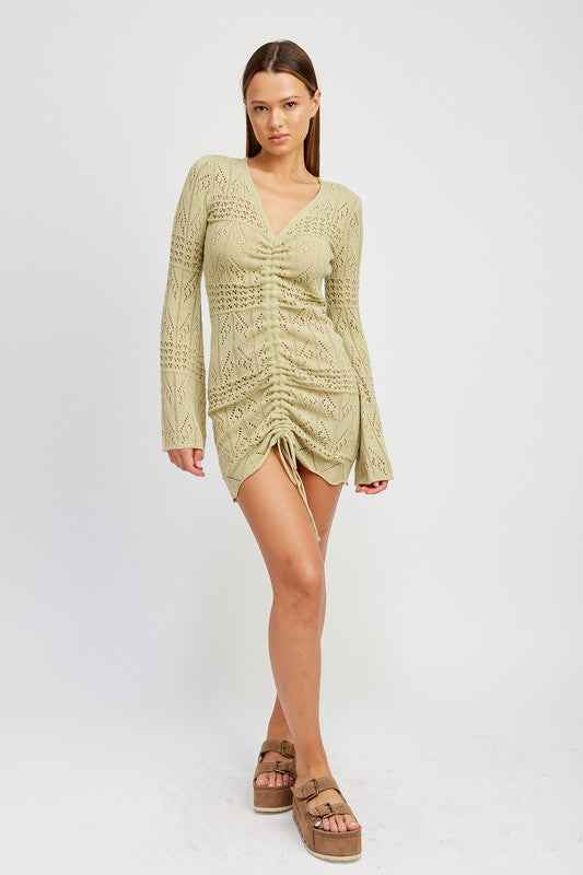 Emory Park ruched crochet mini dress in light green featuring long sleeves and adjustable drawstrings