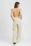 Back view of women's cargo jumpsuit by Emory Park featuring a halter design and relaxed fit