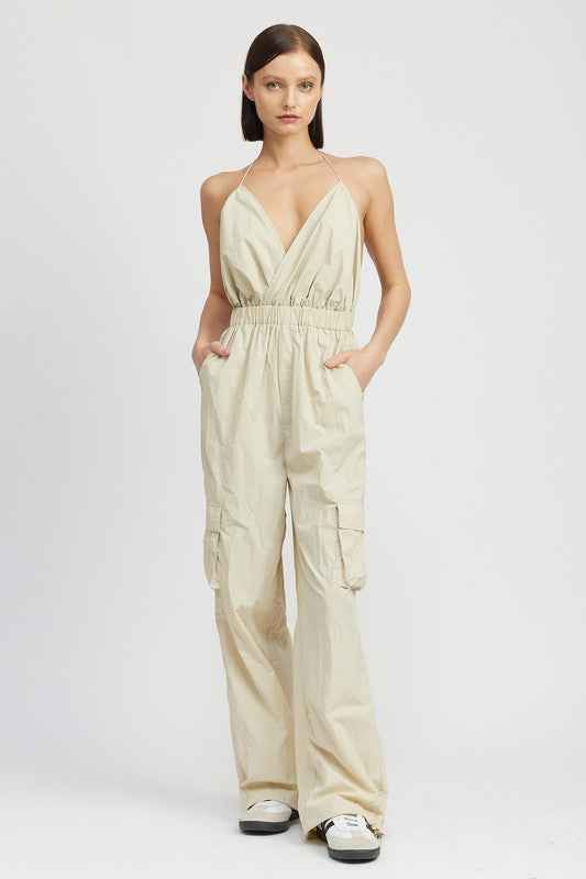 Emory Park women's cargo jumpsuit in light beige with a halter neck design and practical side pockets