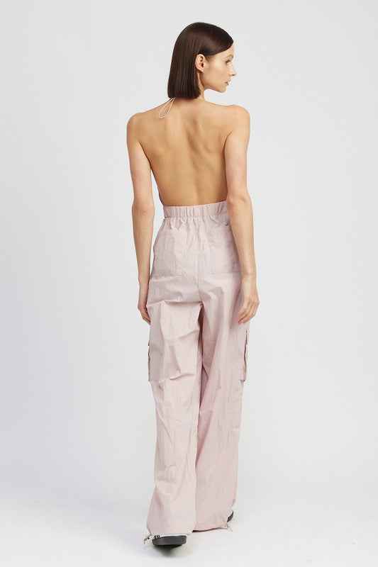 Back view of a women's cargo jumpsuit by Emory Park featuring a stylish halter neck and relaxed fit