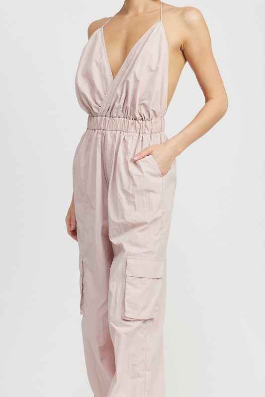 Emory Park women's cargo jumpsuit in light pink with a deep V-neck and adjustable straps