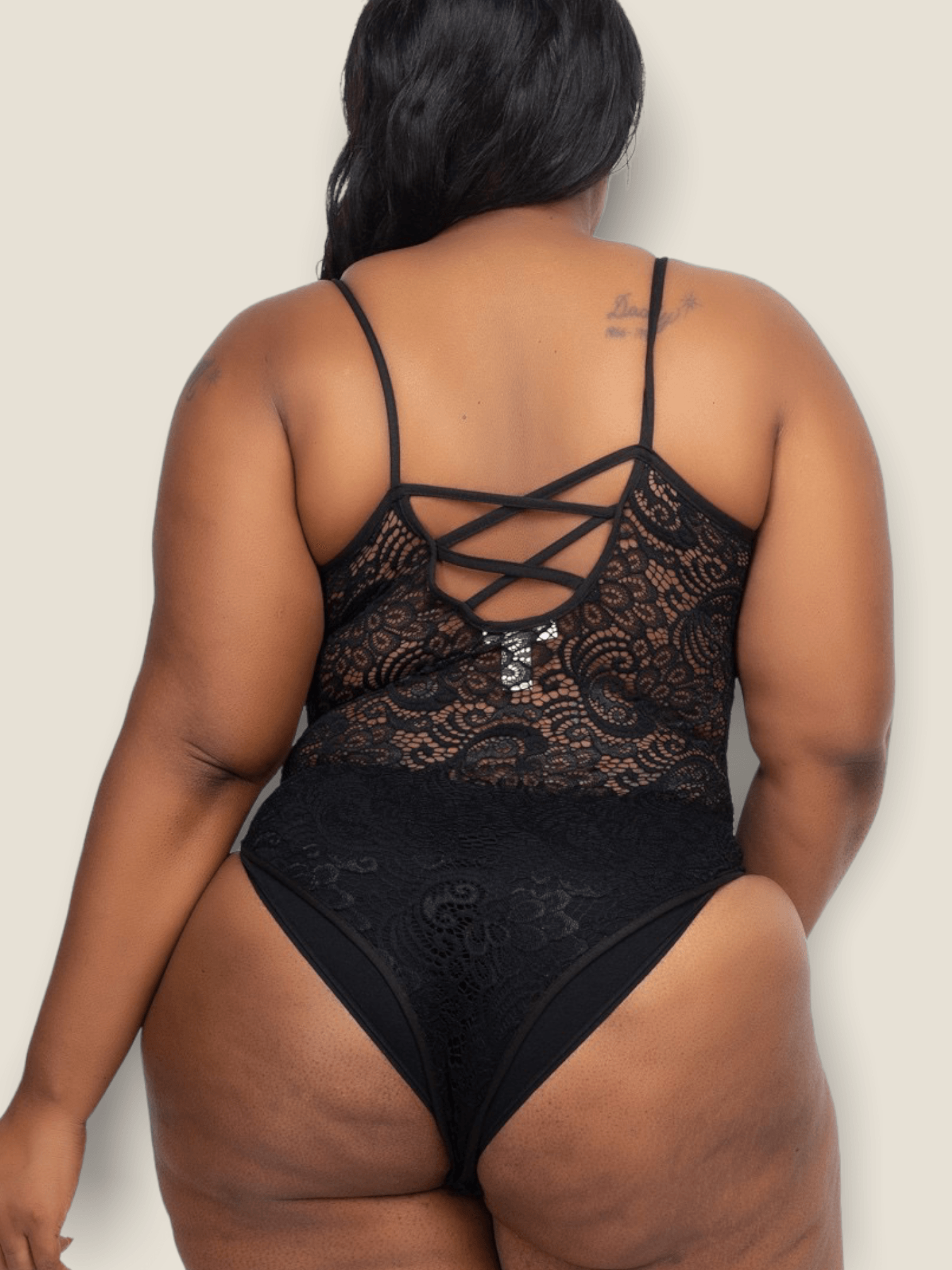 Plus size lace bodysuit in black with a stylish back design for a chic look.