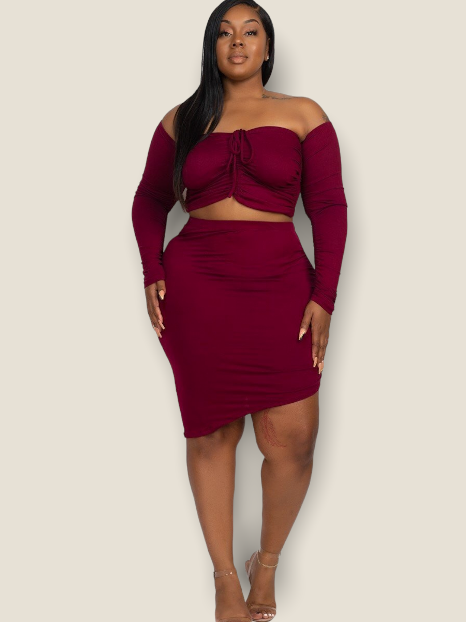 Plus size red skirt set featuring a stylish crop top with long sleeves and a flattering fitted skirt