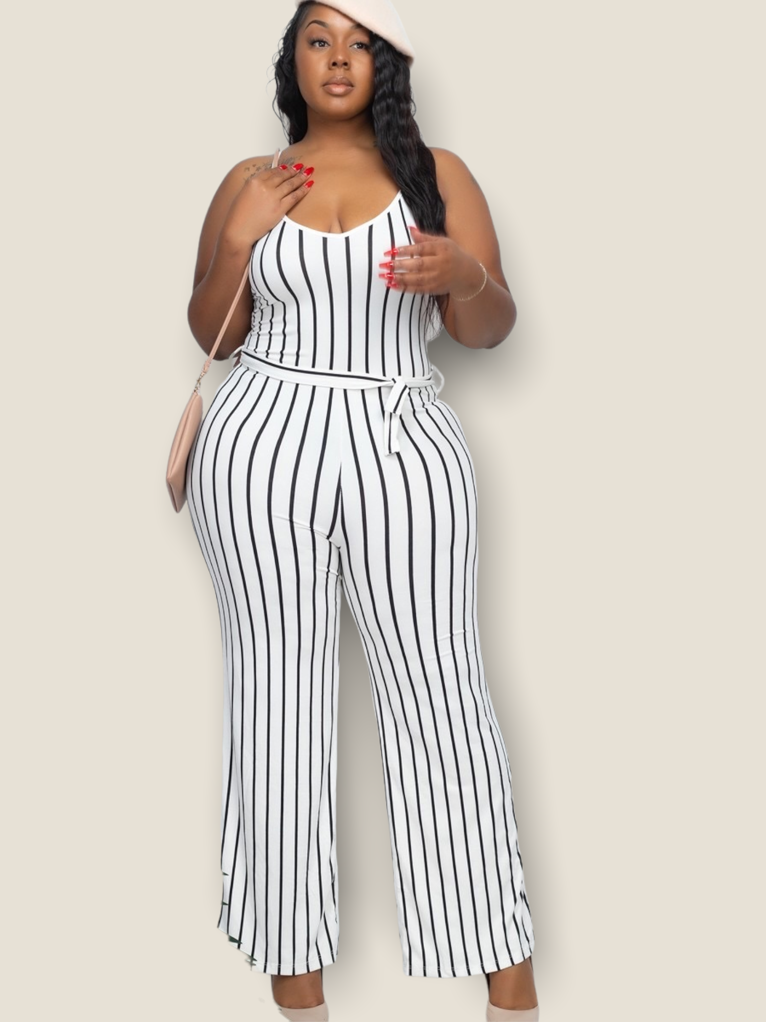 Plus size white striped jumpsuit with a flattering fit and belted waist for stylish summer wear