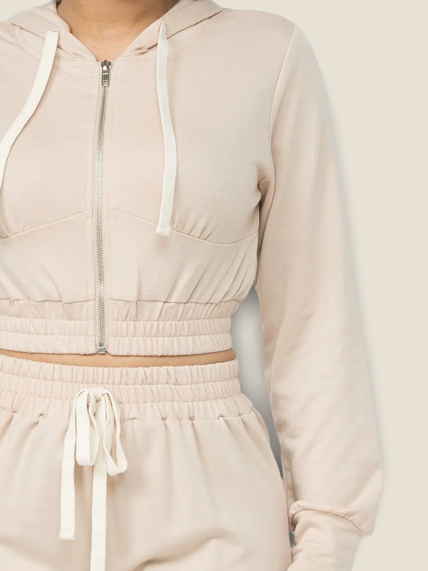 Stylish women's oatmeal jogger set featuring a zip-up cropped hoodie and matching joggers