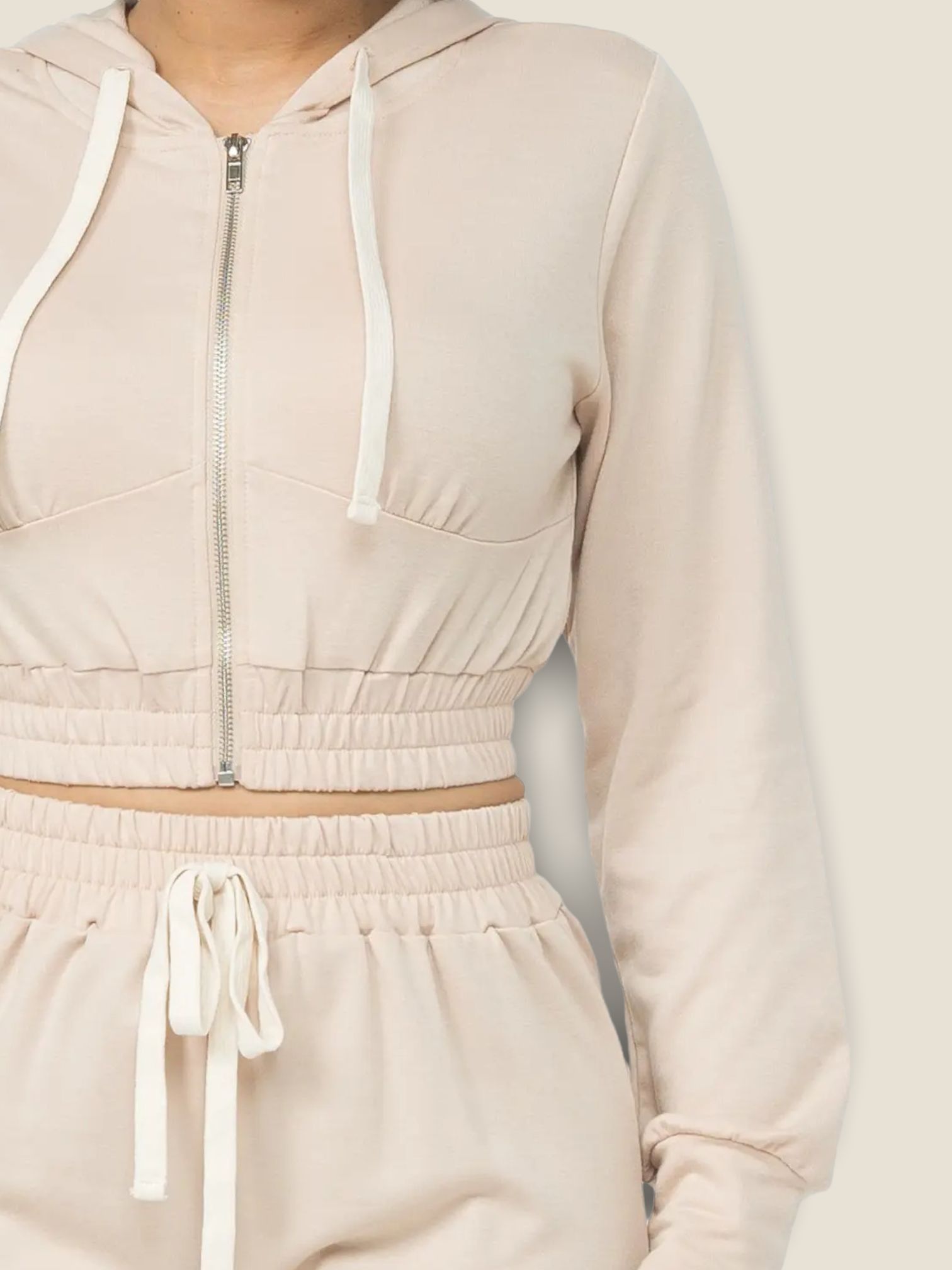 Stylish women's oatmeal jogger set featuring a zip-up cropped hoodie and matching joggers
